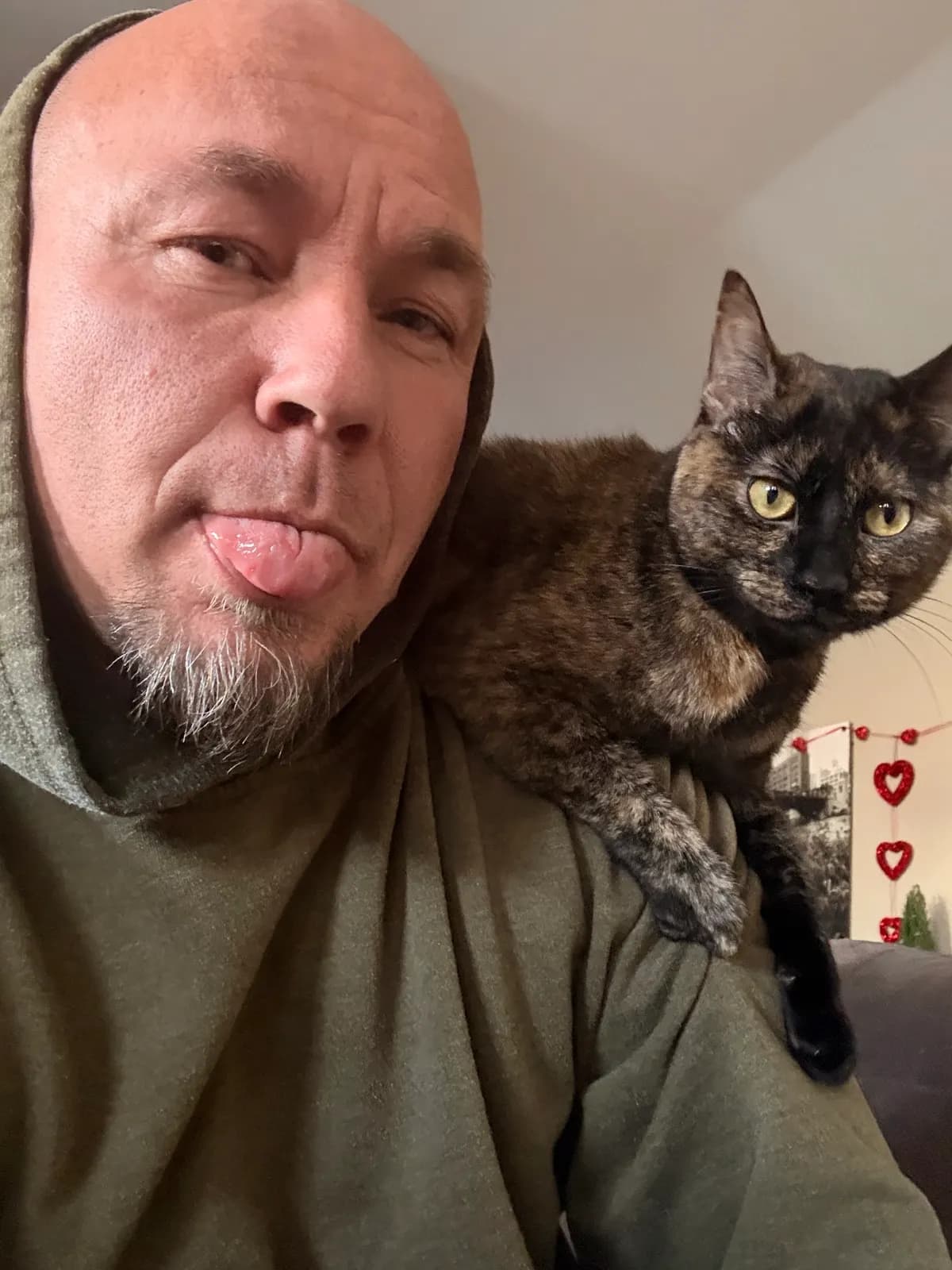 Chris with the family cat on his shoulder